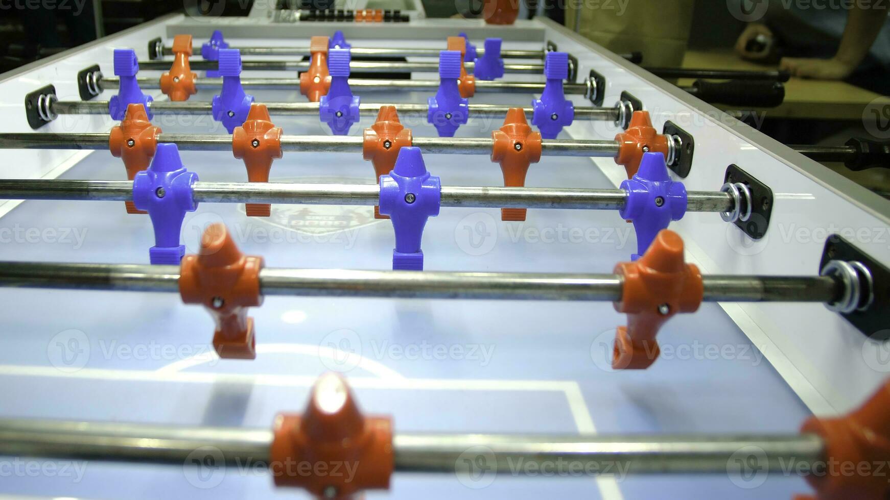 Table football soccer game kicker . Table football game, Soccer table with red and blue players. Young friends playing table football together indoors photo