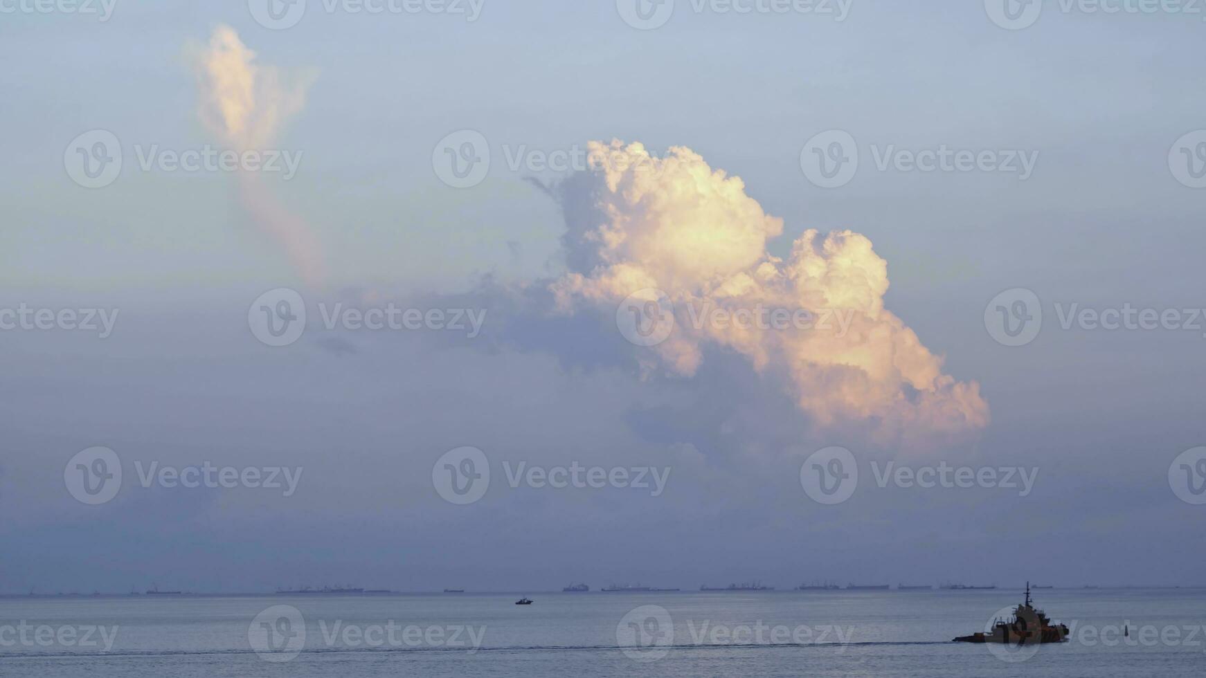 View of a passing ship near the sea shore. Shot. Beautiful view of the sea and clouds photo