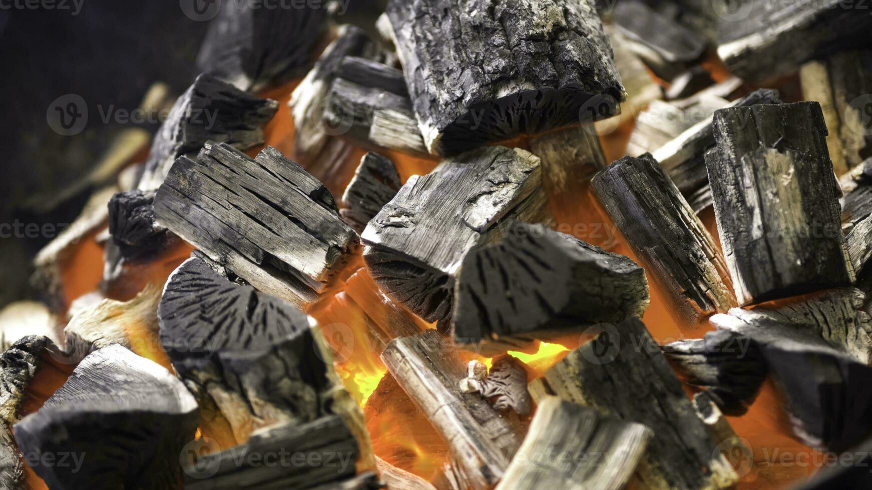 TView Of Hot Flaming Charcoal Briquettes Glowing In The BBQ Grill Pit. Burning Coals For Cooking Barbecue Food. Close Up photo