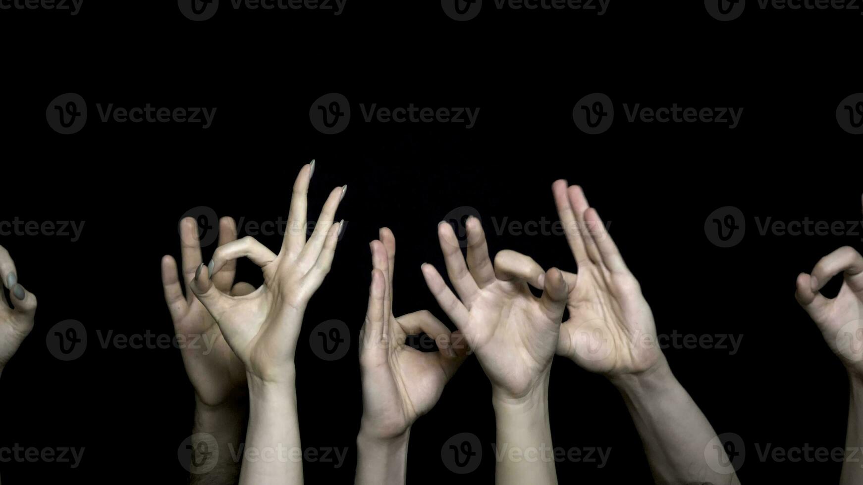 Hands making Okay or flicking sign. Okay coding by hand isolated on black background. Hands show gesture ok or everything is good isolated on black background photo