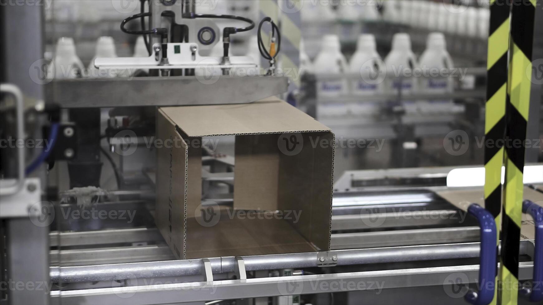 Cardboard boxes on conveyor belt in factory. Clip. Cardboard boxes on conveyor belt in factory photo