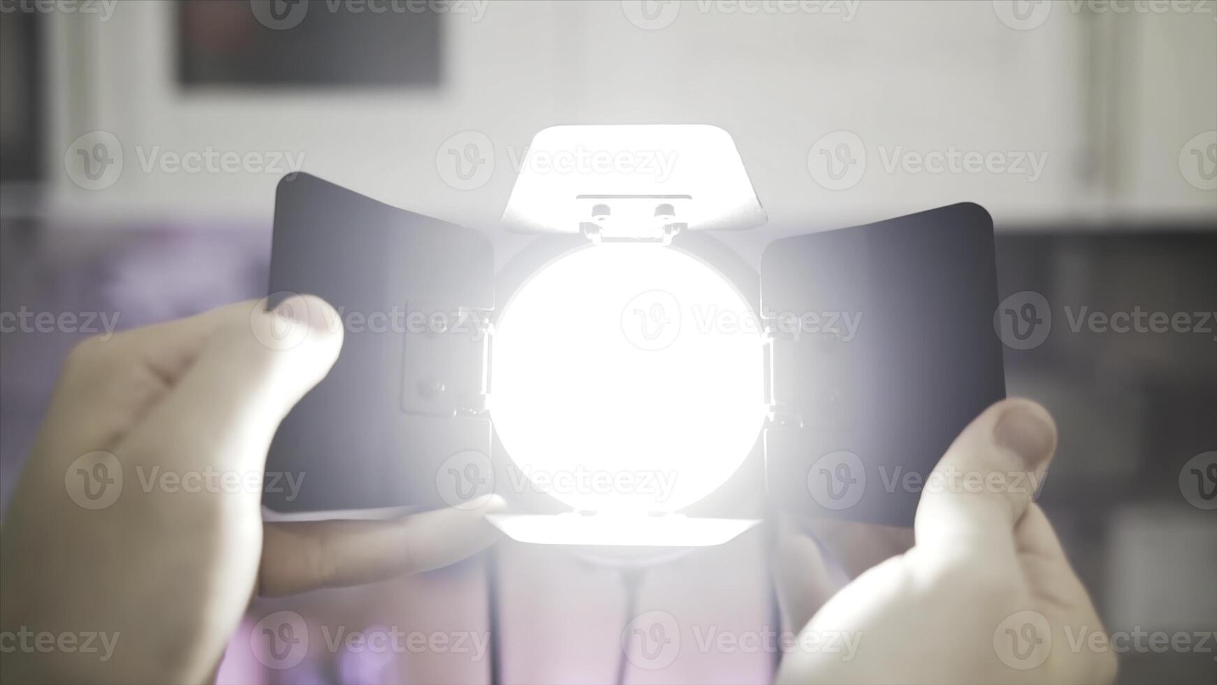 Close up of hands touching blades of tracking light. Action. Male hands making diffused light instead of spot light, electric illumination of the room. photo