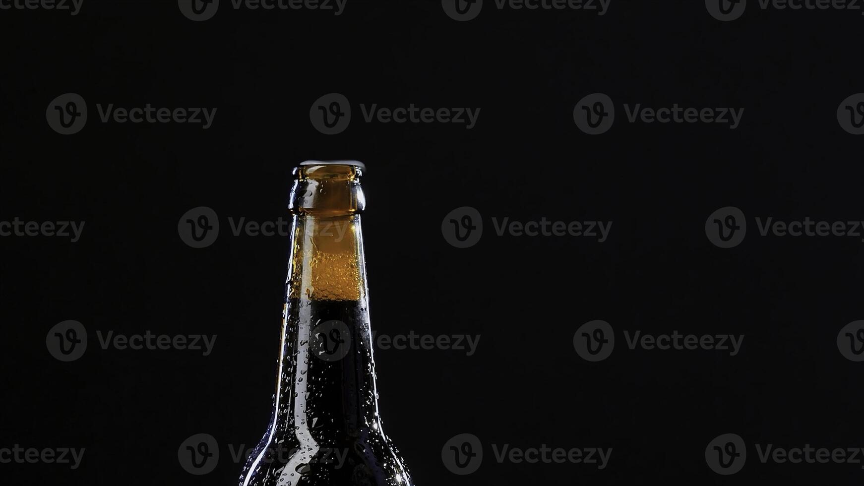 Close up of a hand opening a glass bottle. Video. Alcoholic drink isolated on black background, concept of party. photo