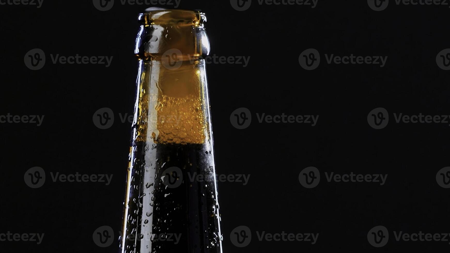 Close up of a hand opening a glass bottle. Video. Alcoholic drink isolated on black background, concept of party. photo