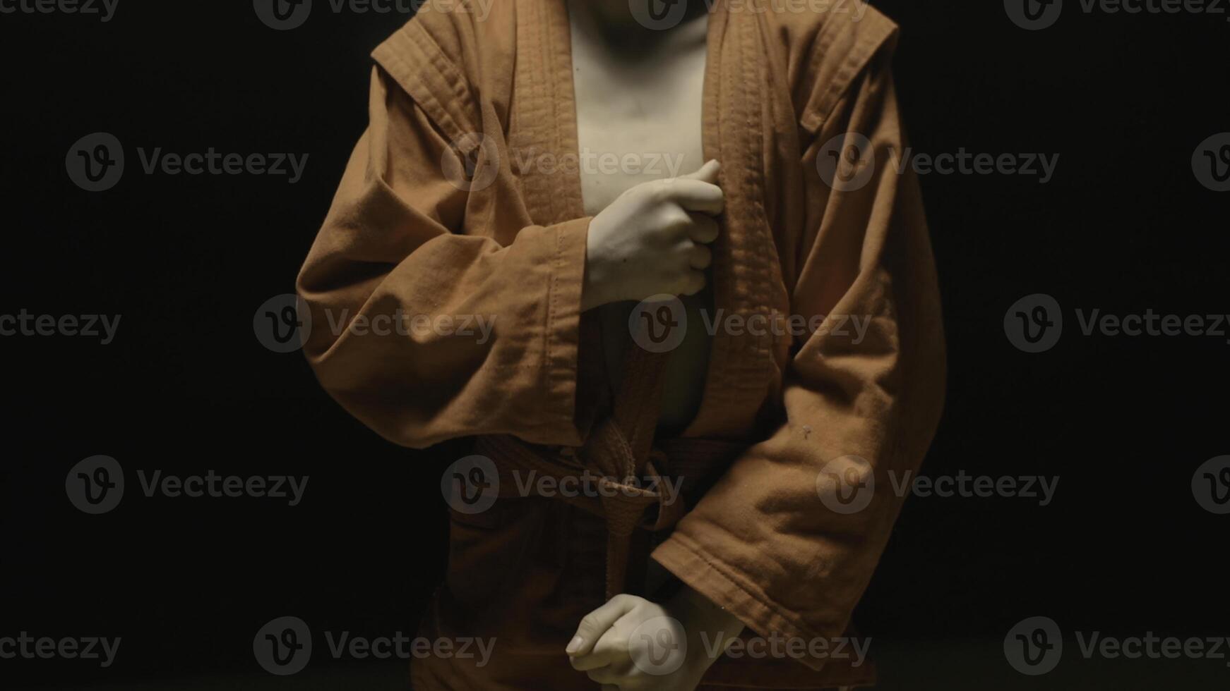 Sportsman boy in a red kimono for judo. Boy puts on a red kimono in preparation for training or sparring photo