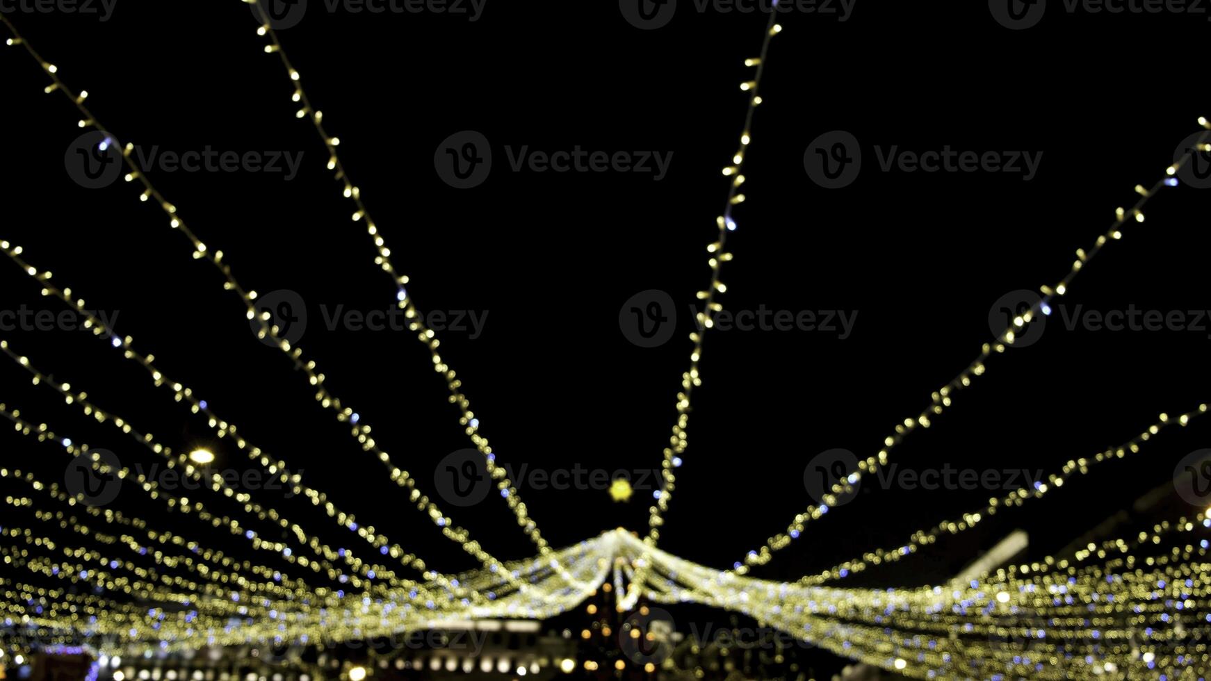 Bright twinkling decorations of festive new year city at night. Concept. Glowing decorations with garlands illuminate night city and create festive new year mood photo