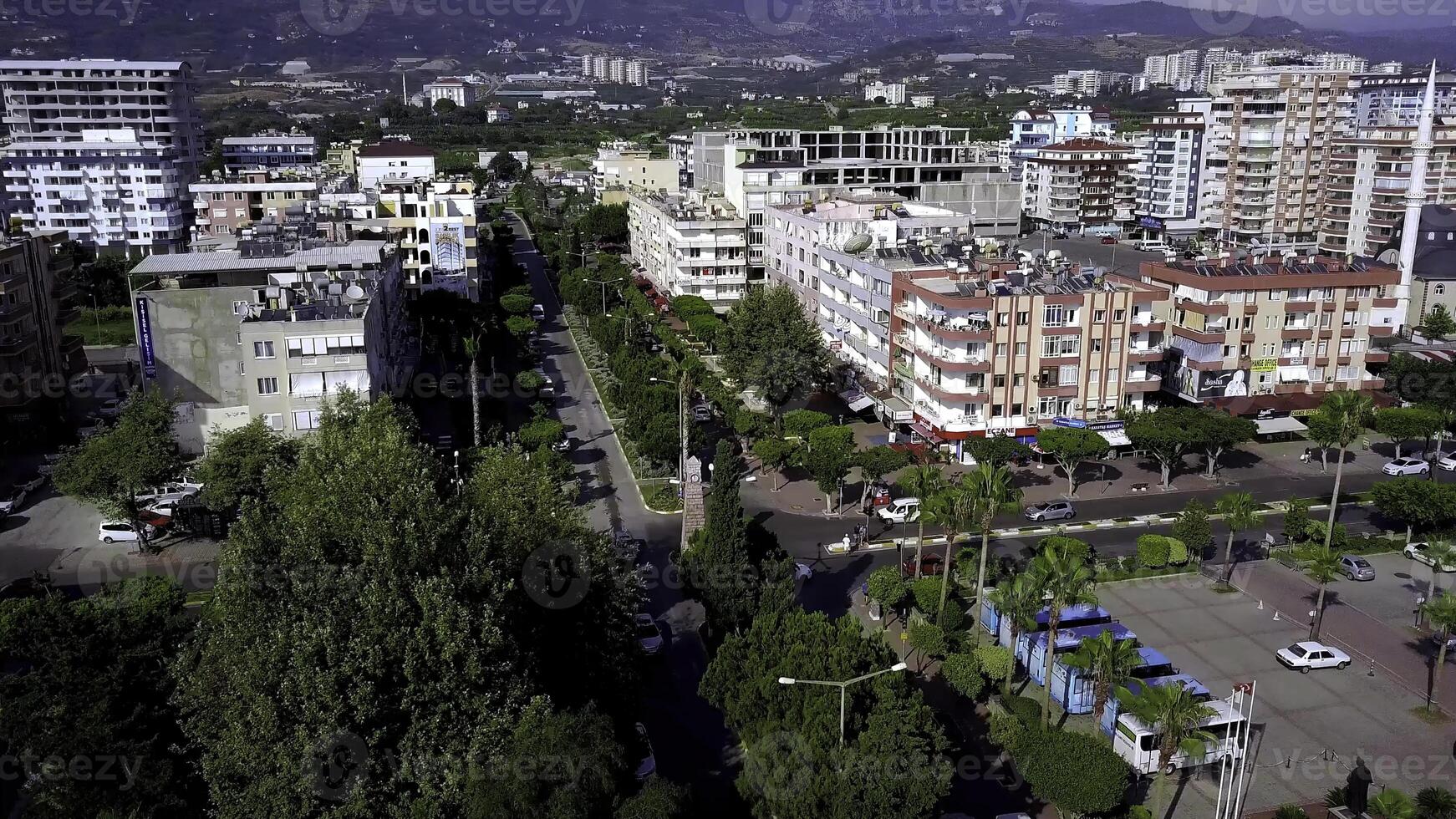 Top view of resort town on sea coast on background of mountains. Clip. Southern resort town located on coast is separated from sea by highway photo