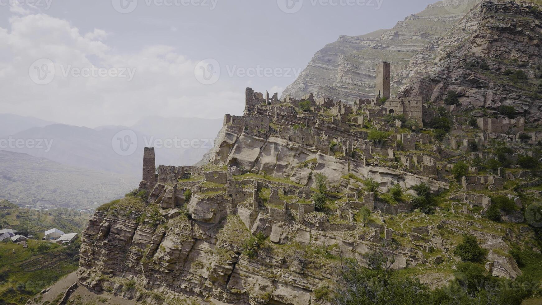 Top view of amazing stone city in mountains. Action. Ancient stone city on rock in mountains. Abandoned stone city in mountains photo
