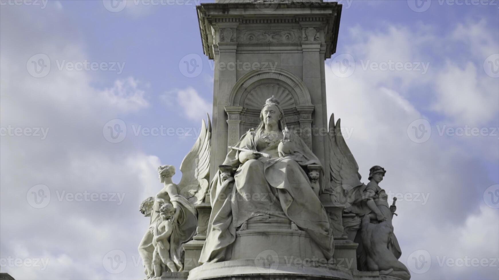 Victoria Memorial At Buckingham Palace on blue cloud background. Action. Queen Victoria Memorial in front of Buckingham Palace at London, England photo