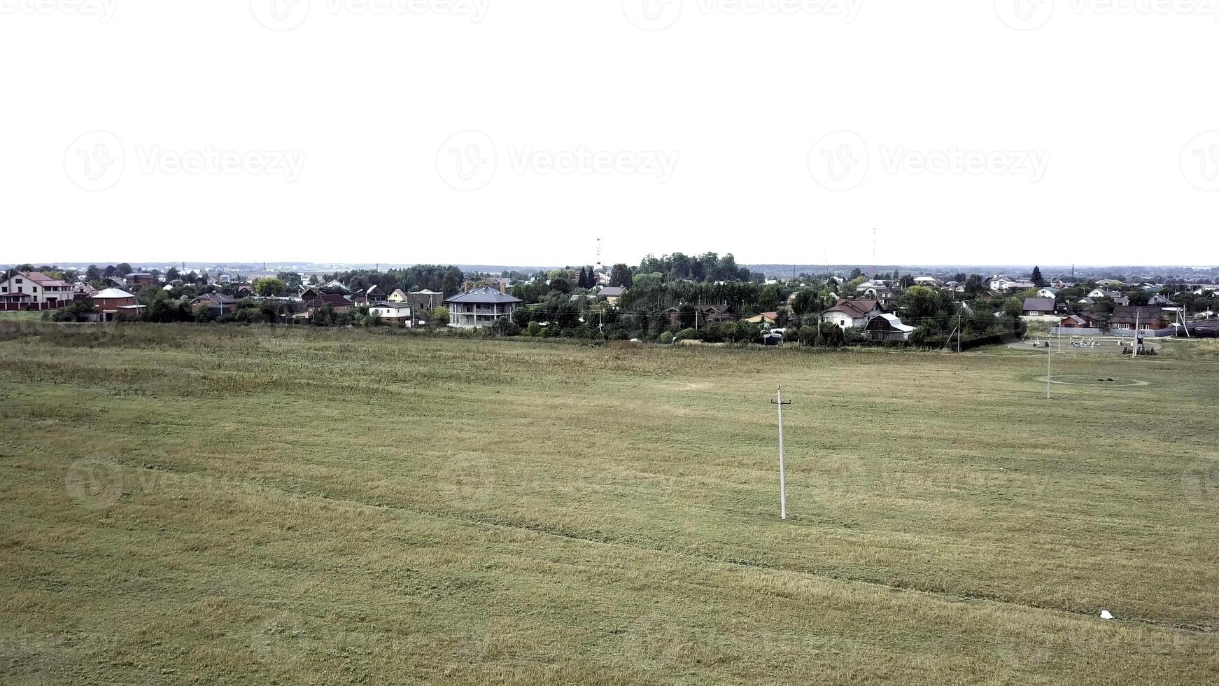 Top view of the luxurious village. Stock footage. A view of the village from the top of a mountain in the national park is trapped with clouds in the sky on a sunny day photo