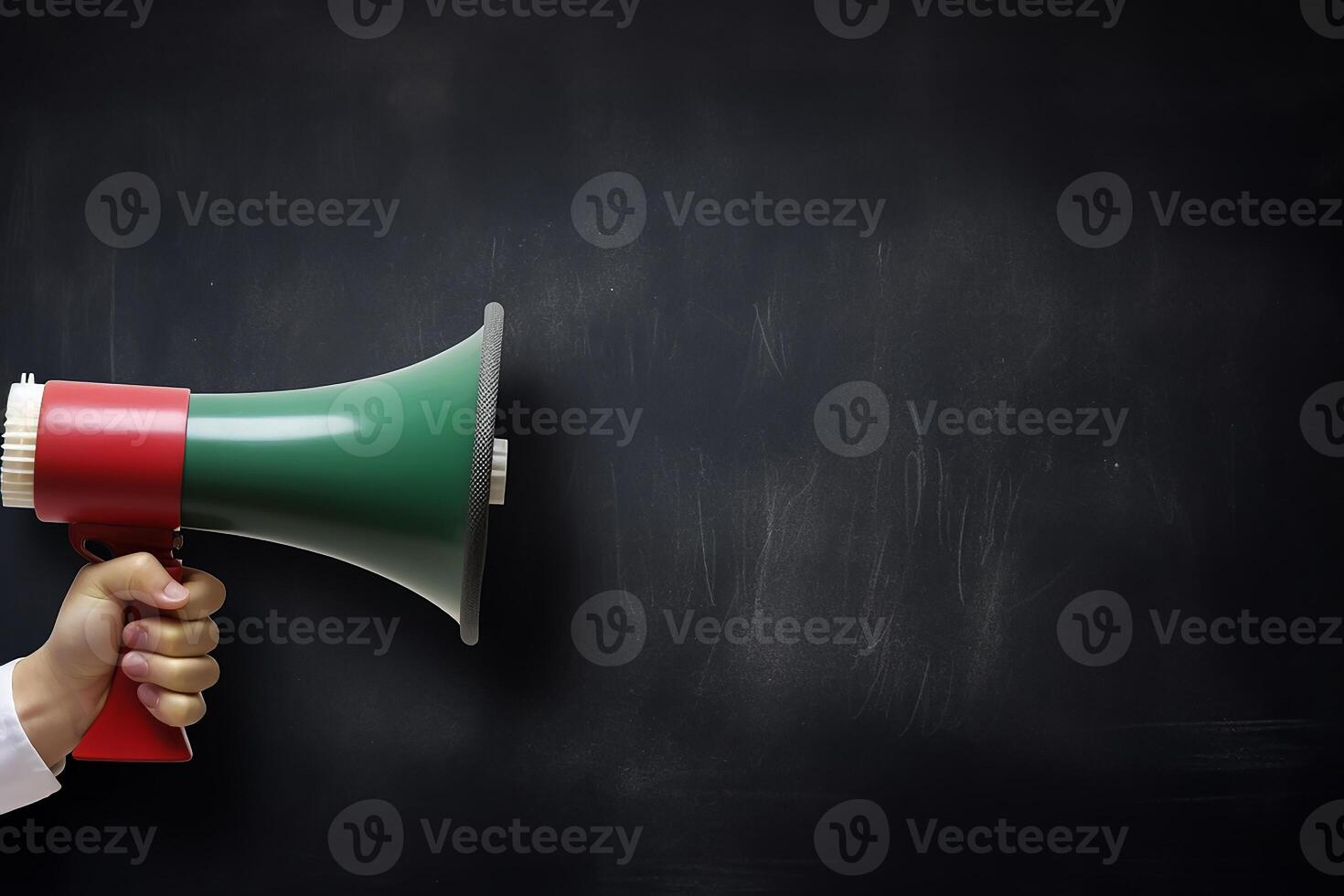 AI generated Hand holding megaphone over chalkboard background with copy space photo