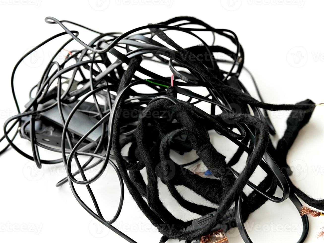 Tangled roll of black wires isolated on white background. Clip art. E-waste mess concept. photo