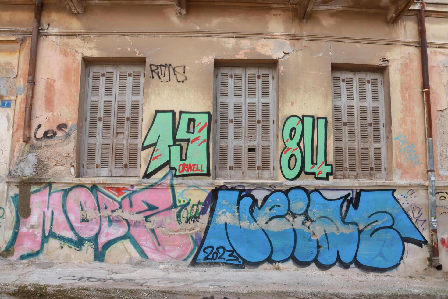Athens, Greece, December 15 2023 Colorful but unlawful graffiti plastered on walls and city building in Athens photo