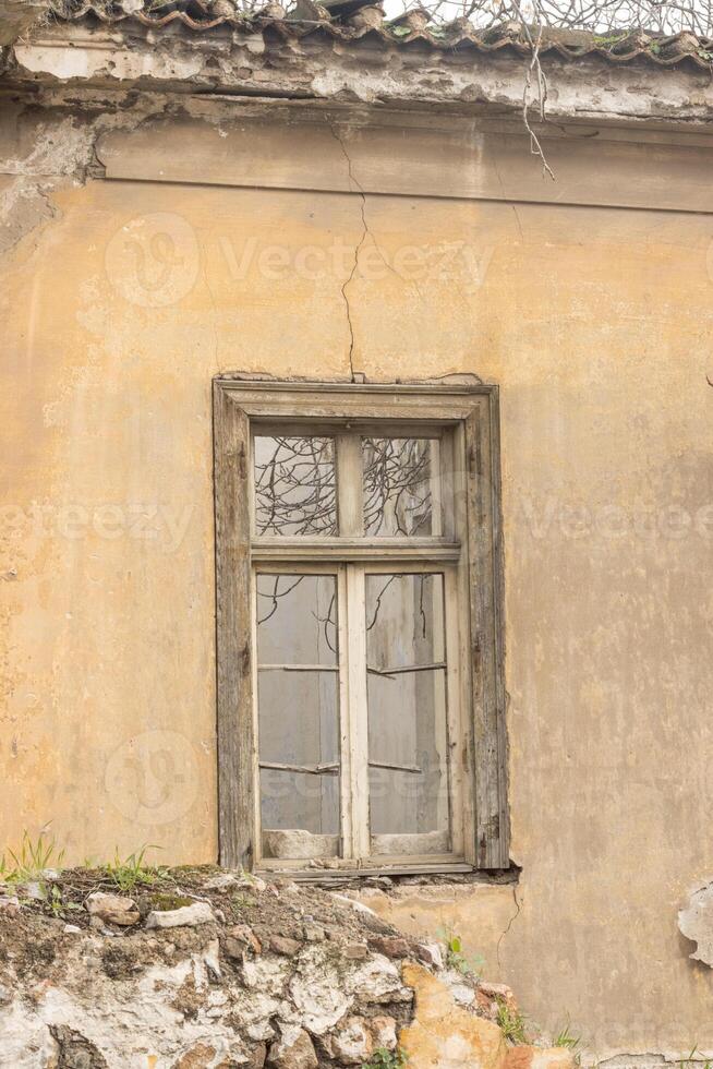 Old abandon home with broken window that can be found throughout the city in Athens, Greece photo