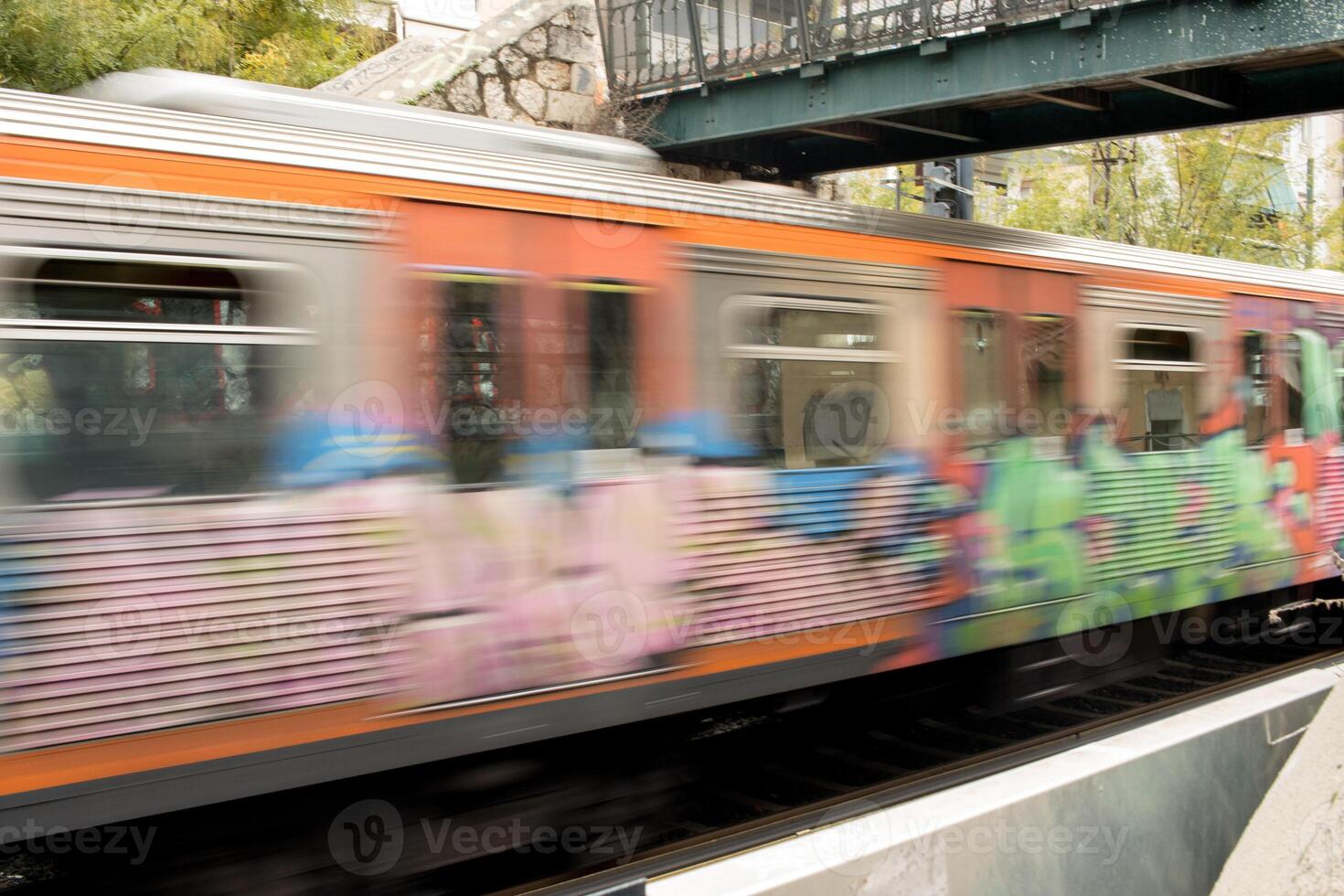 Motion blur of a train traveling at a high rate of speed in an urban area photo