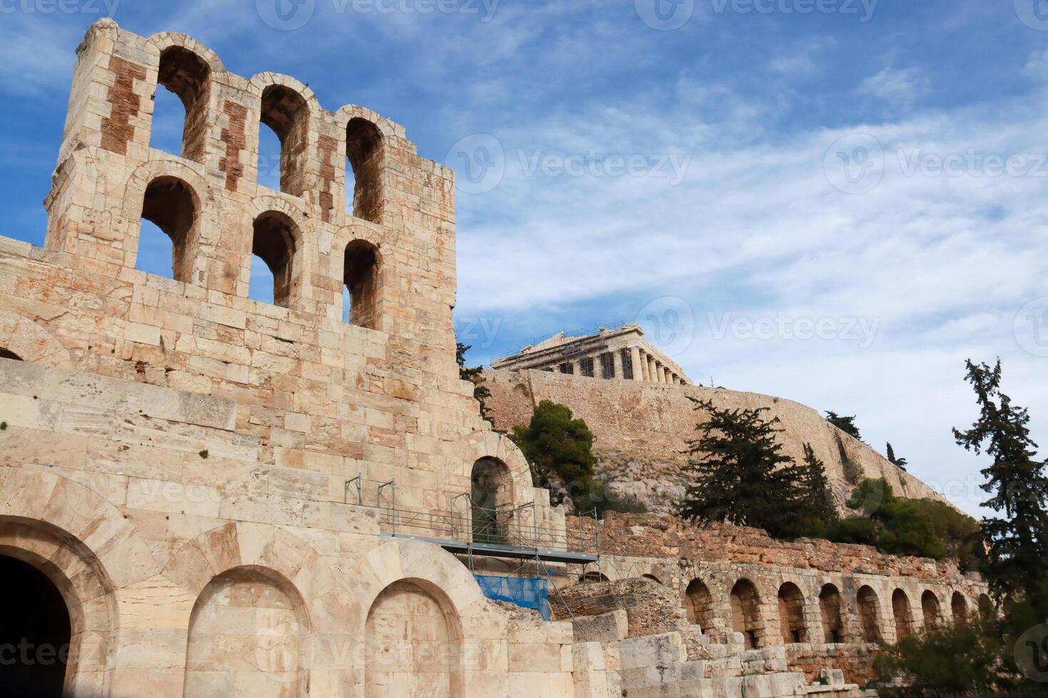 View of part of the Odeon of Herodes Atticus Theater foreground and the Parthenon in background photo