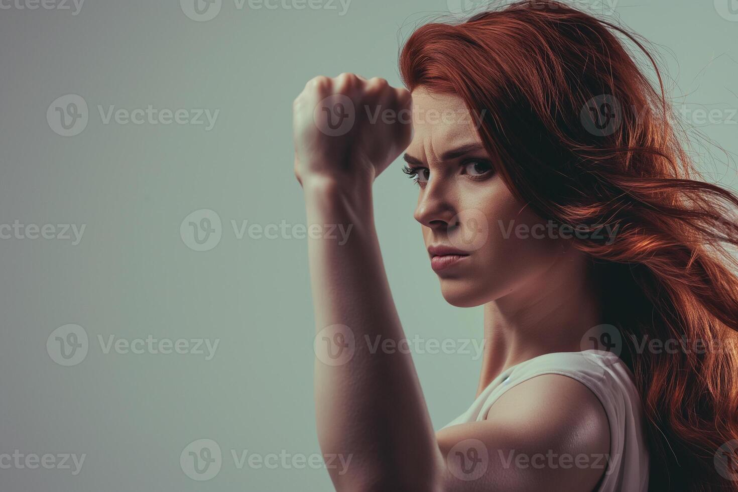 AI generated woman with flowing hair with raised fist, girl power photo