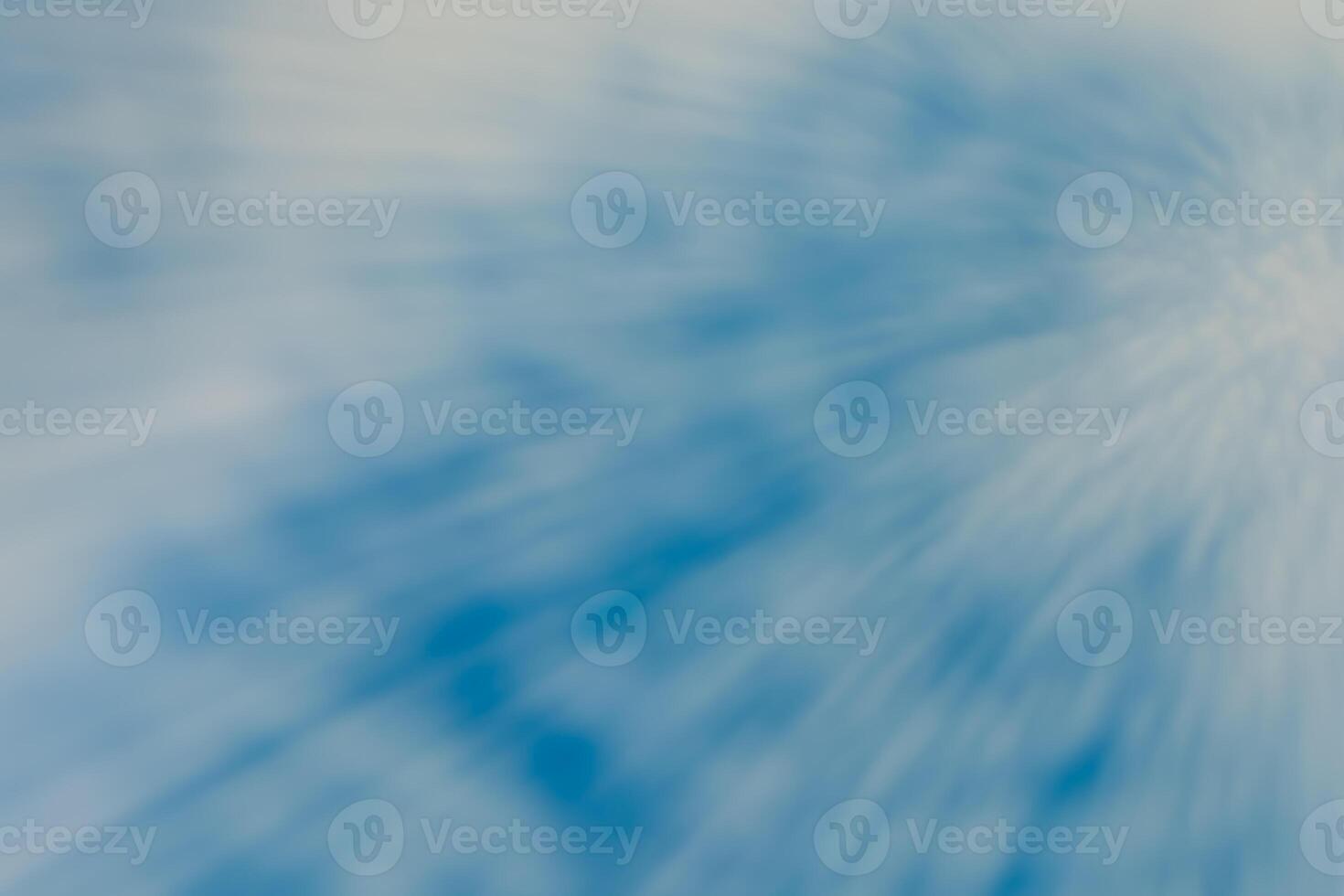 Abstract horizontal spotted background of blurred blue sky with clouds and rays of light in motion. Design element with copy space. photo