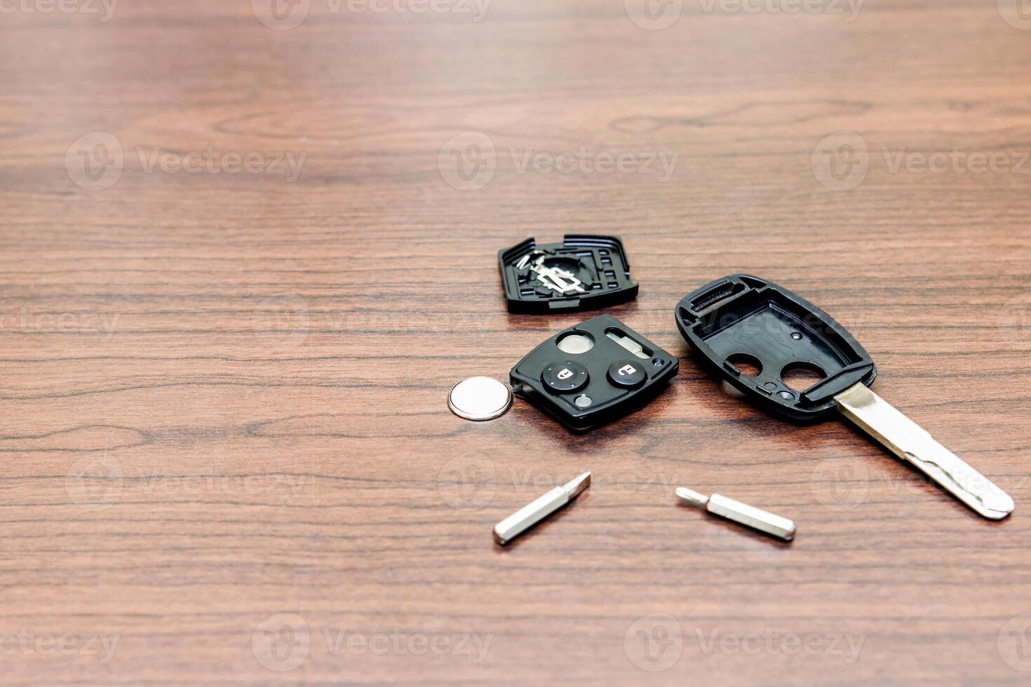 Car key maintenance concept change battery  by screw driver on the wood table photo