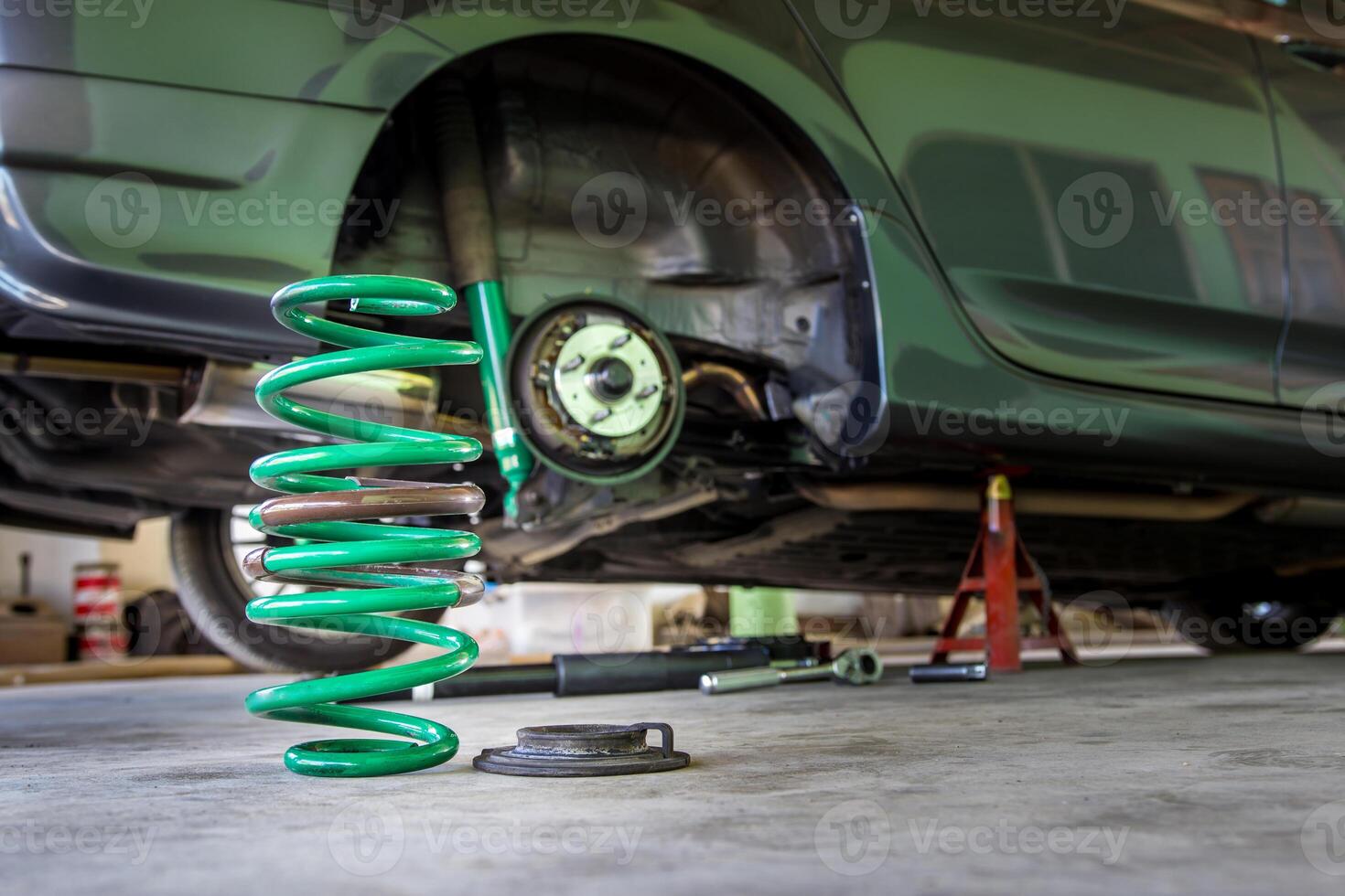 Chang Coil spring and shock absorber on the service shop change and remove old part car maintenance concept photo
