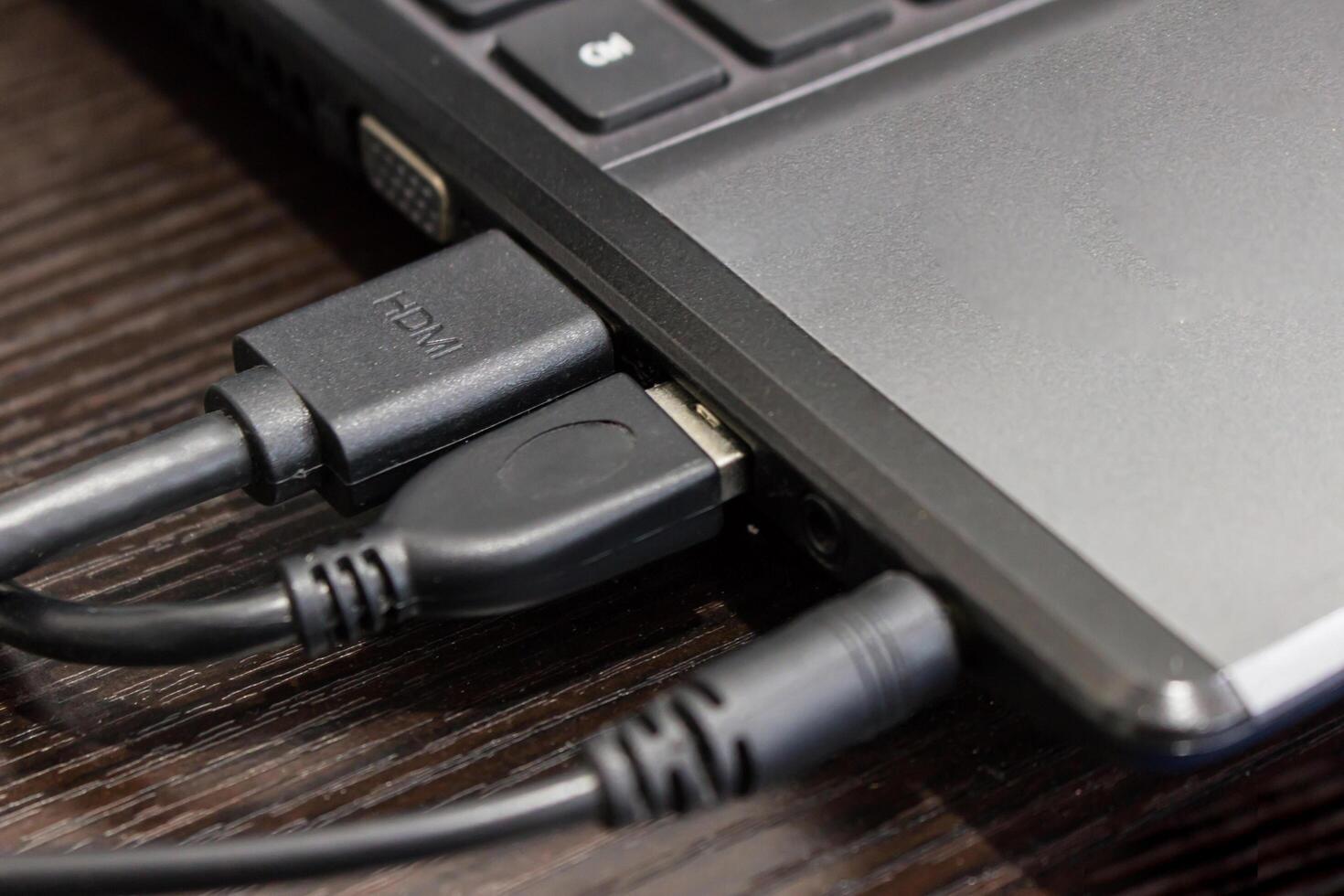 Close up port of computer for audio jack ,USB,hdmi cable connecting on the wood table joint concept photo