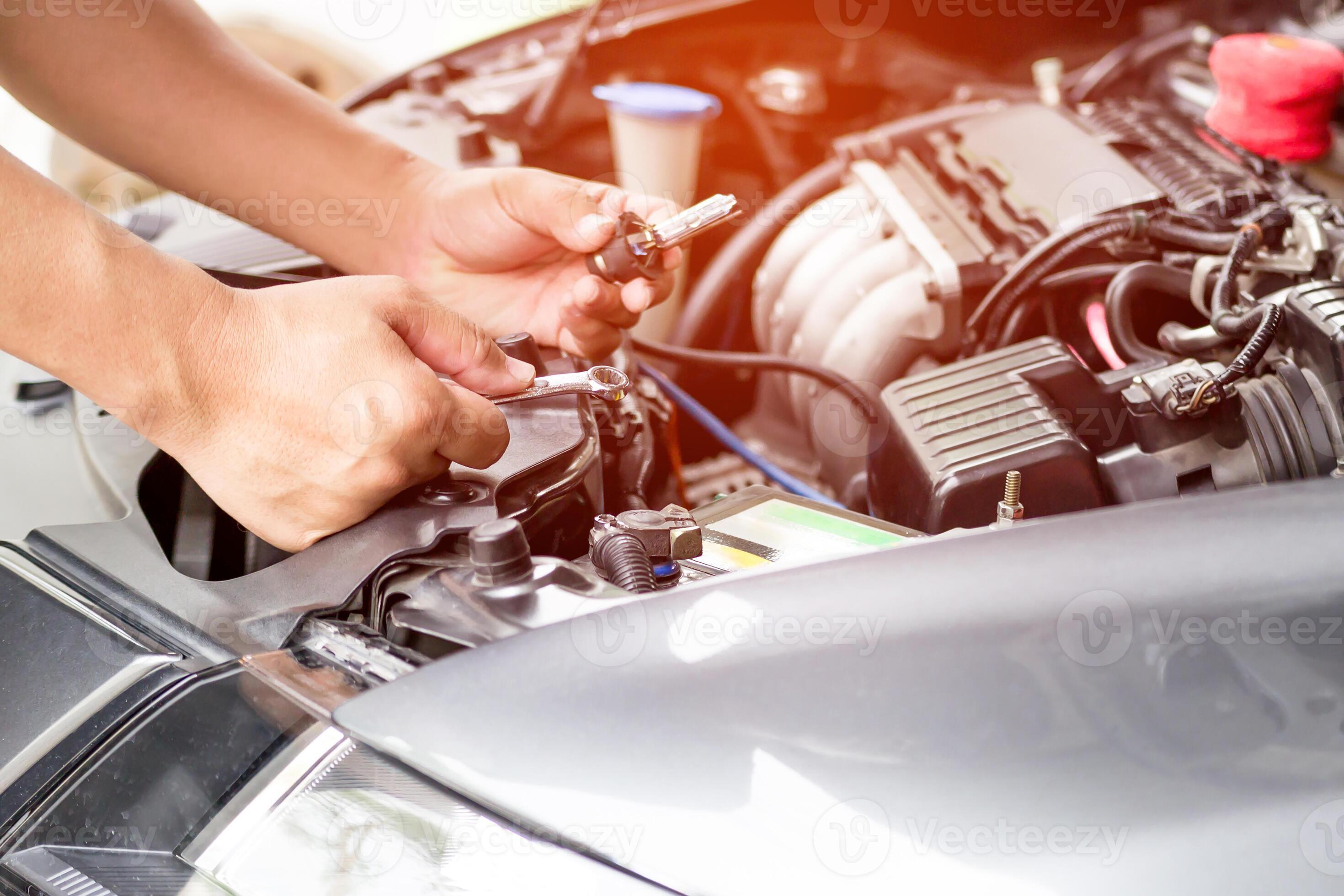 Mechanic man use wrench change headlights xenon Lighting Equipment in