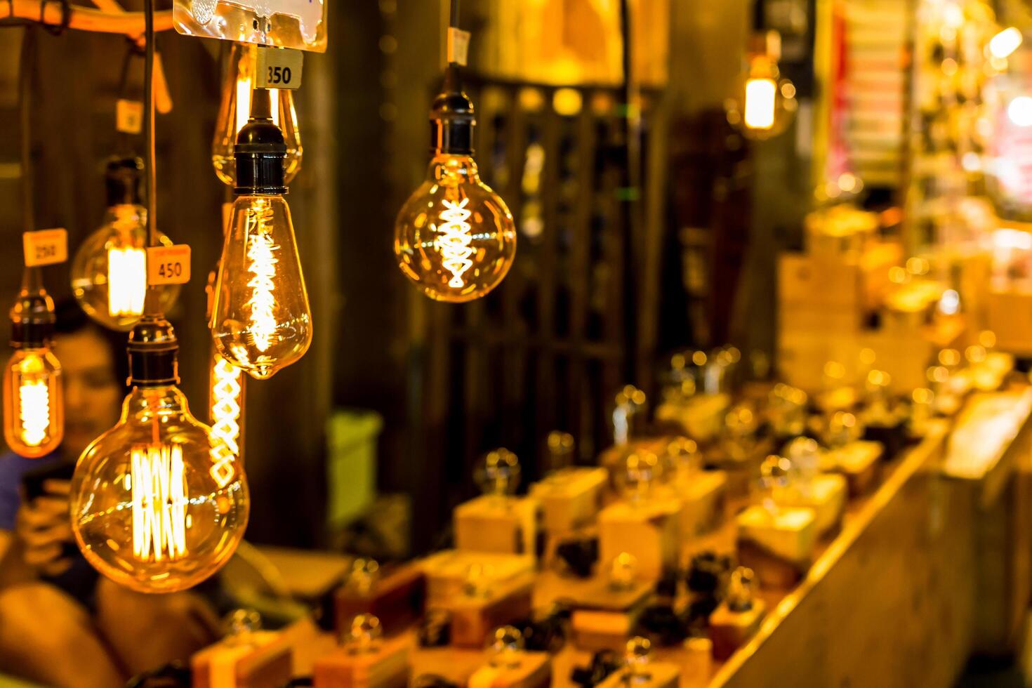 Soft focus of Light bulb in market shop with walking Street photo