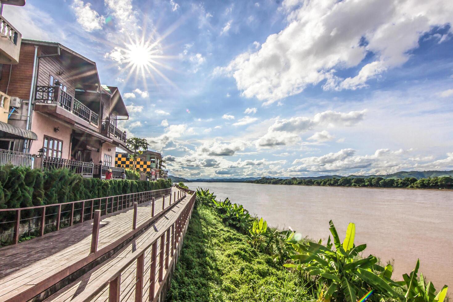 Chiang Khan Kaew Loei,Thailandct Tourists walking in working street in market and hotel with river and blue sky photo