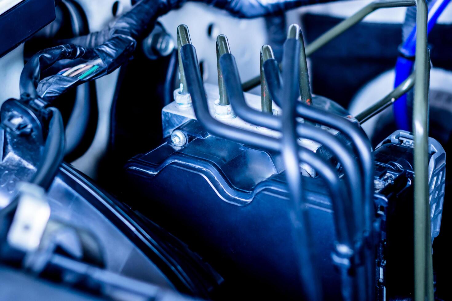 Close up brake ABS part of car system in engine room photo