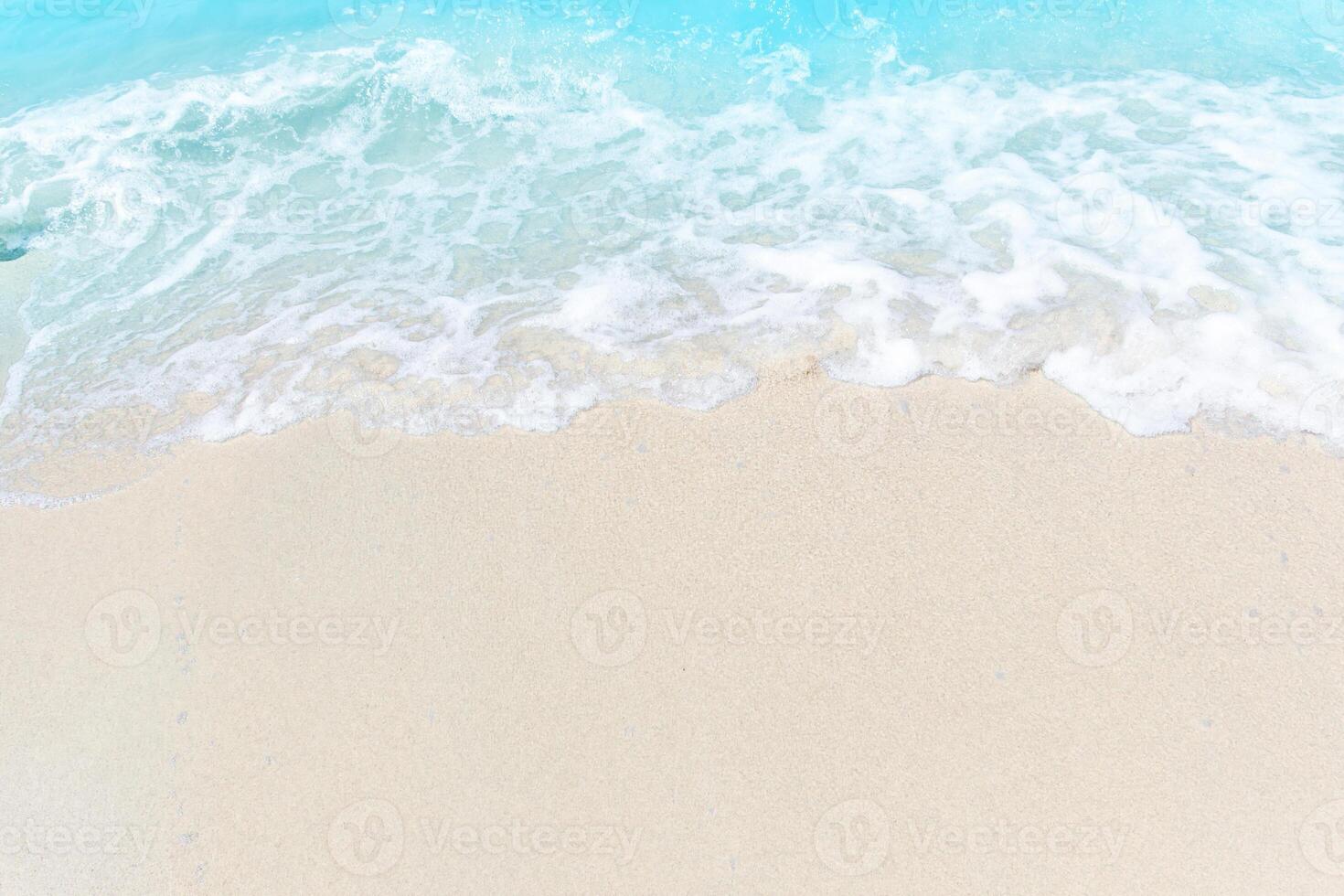 Sea wave and bubble on a sandy white beach blue sea background texture and copy space holiday concept photo