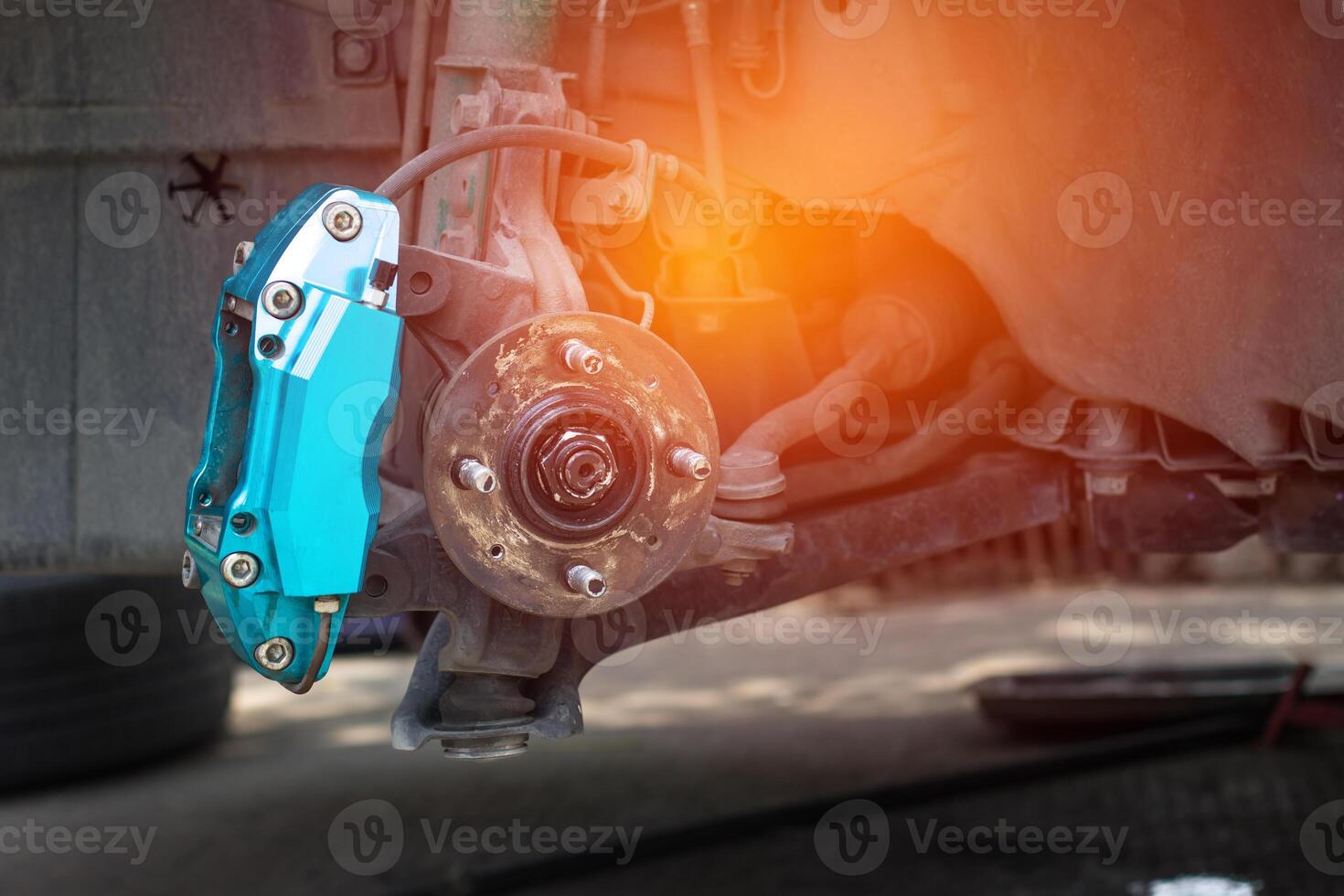 Close up brake caliper and front old bearing of car maintenance cycle and change brake pad,car service concept in shop photo