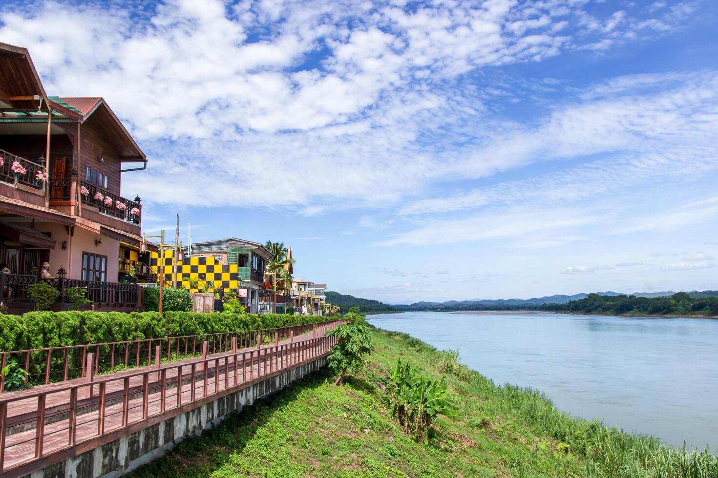 Chiang Khan Kaew Loei,Thailand Tourists walk in working street in market and hotel with river and blue sky photo