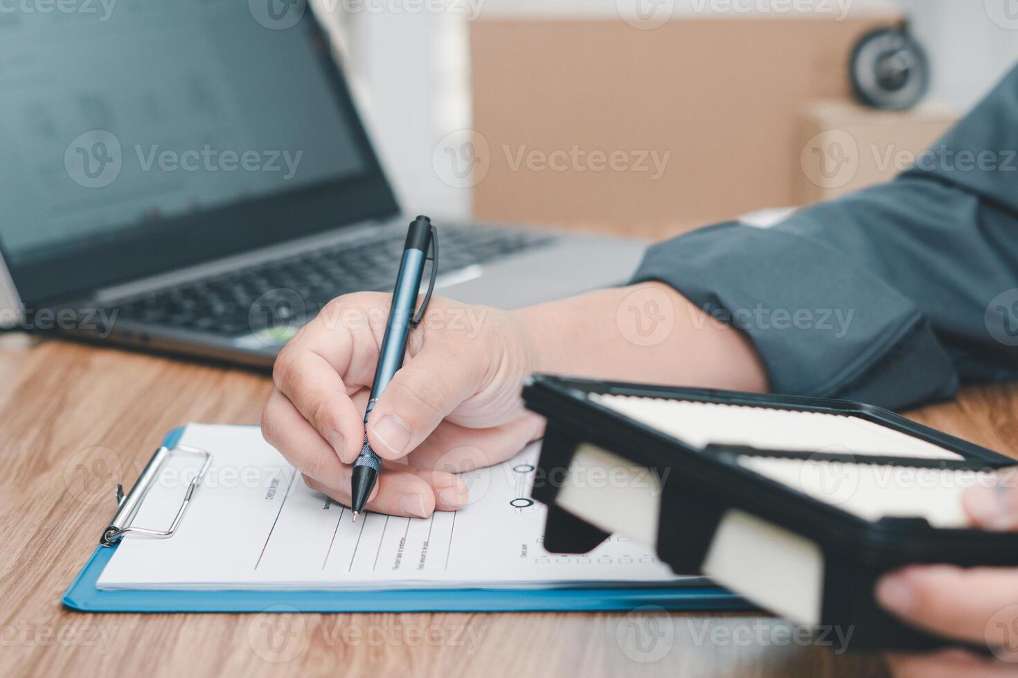 Car service staff writing on the white paper clip file board and hold car air engine filter for check auto parts for accuracy before replacing in periodic maintenance in the car service photo