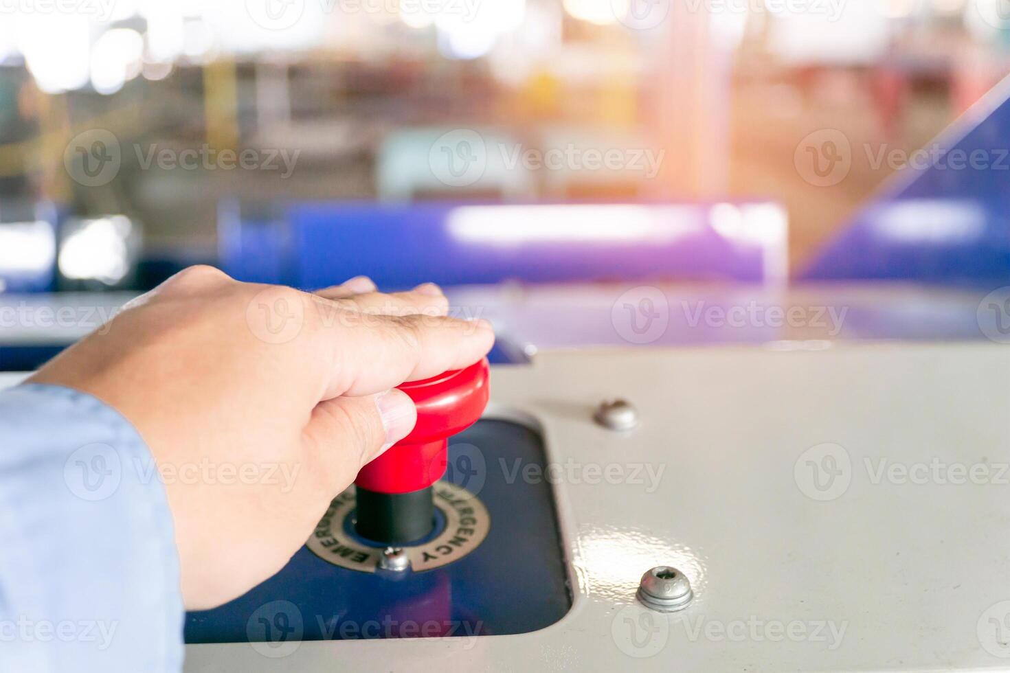 Hand a man Push button emergency switch of electric forklift in blur factory background photo