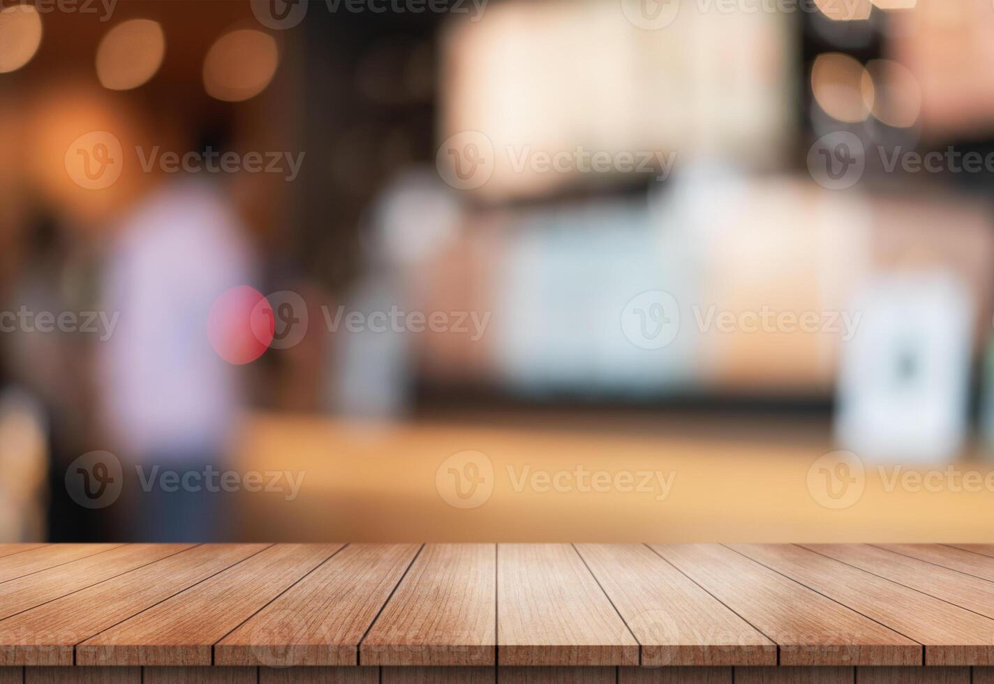 Empty wooden table top with lights bokeh on blur restaurant background. photo