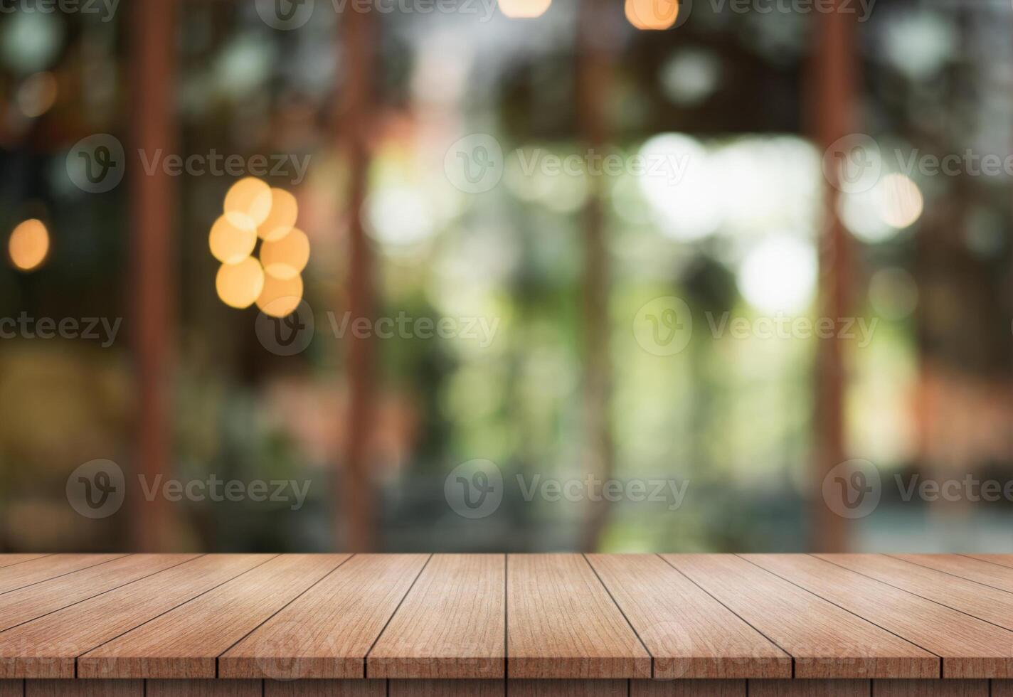 Empty wooden table top with lights bokeh on blur restaurant background. photo