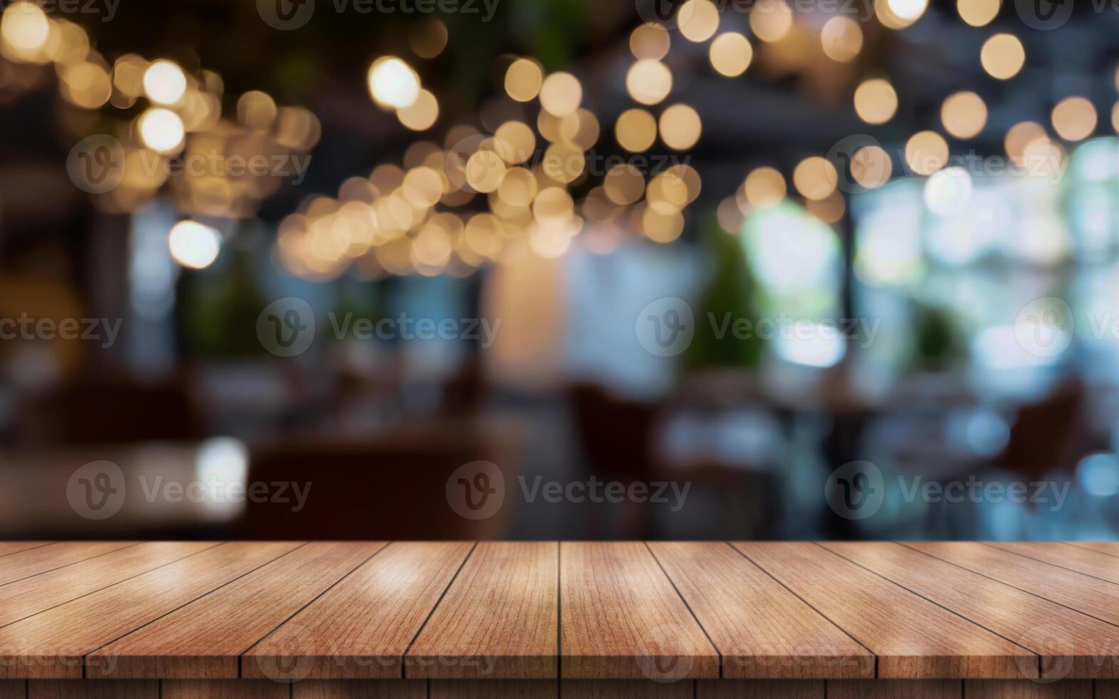 Empty wooden table top with lights bokeh on blur restaurant background photo