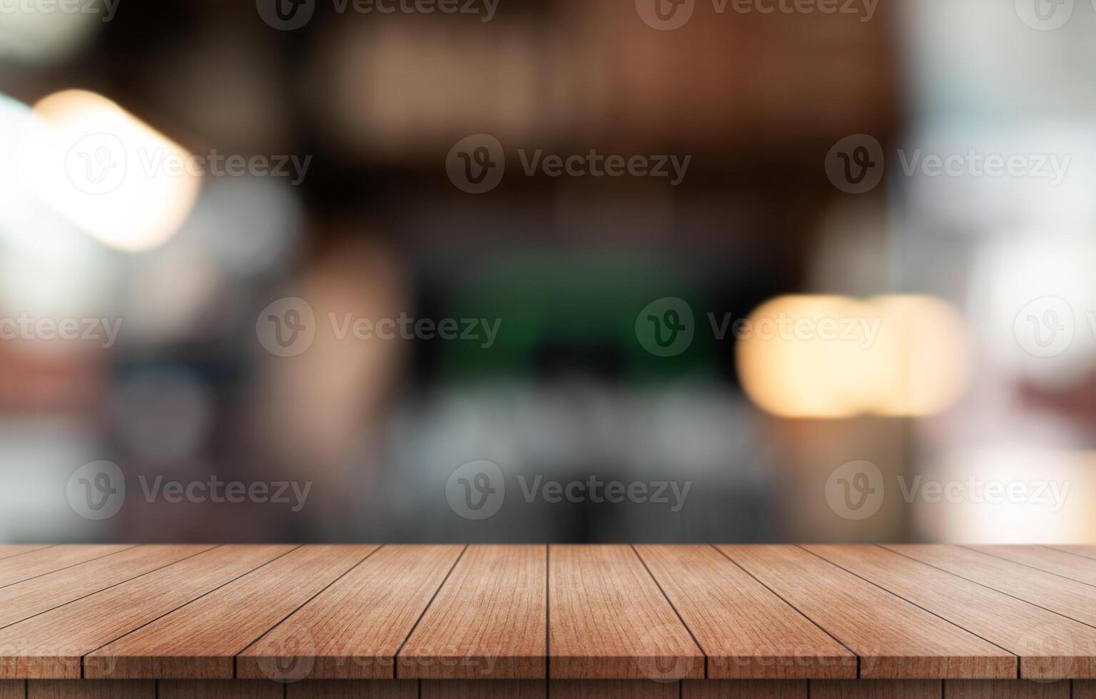 Empty wooden table top with lights bokeh on blur restaurant background. photo
