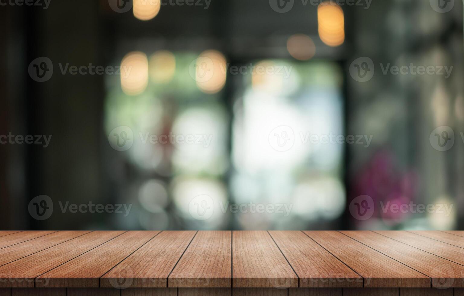 Empty wooden table top with lights bokeh on blur restaurant background. photo