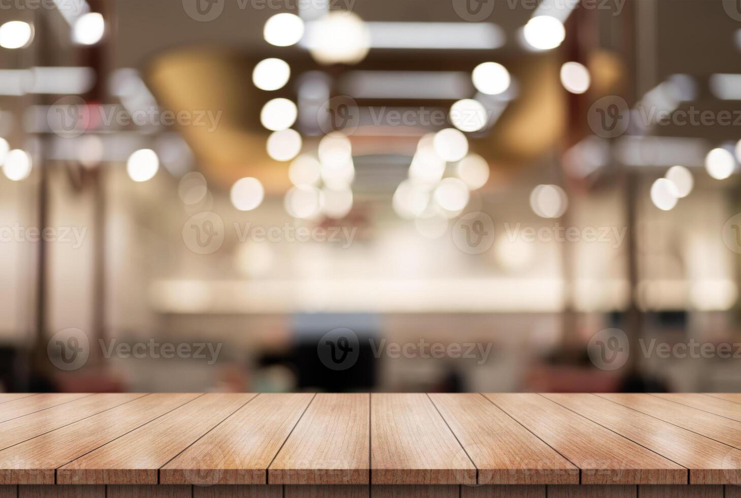 Empty wooden table top with lights bokeh on blur restaurant background. photo