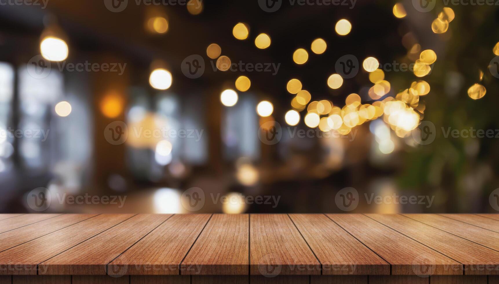 Empty wooden table top with lights bokeh on blur restaurant background photo
