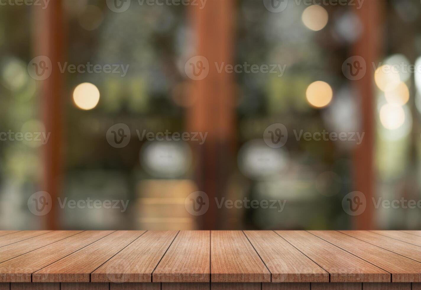 Empty wooden table top with lights bokeh on blur restaurant background. photo