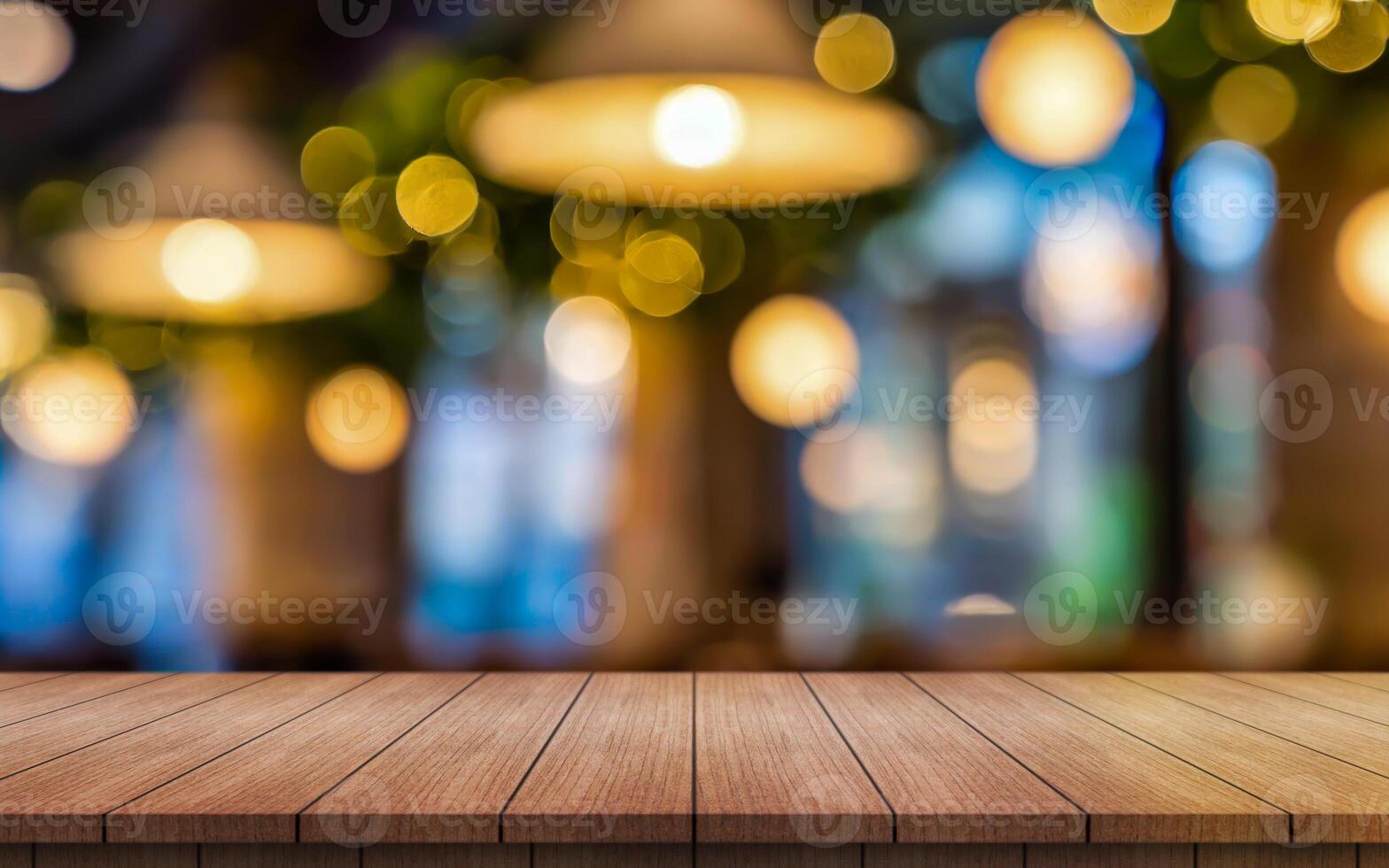 Empty wooden table top with lights bokeh on blur restaurant background photo