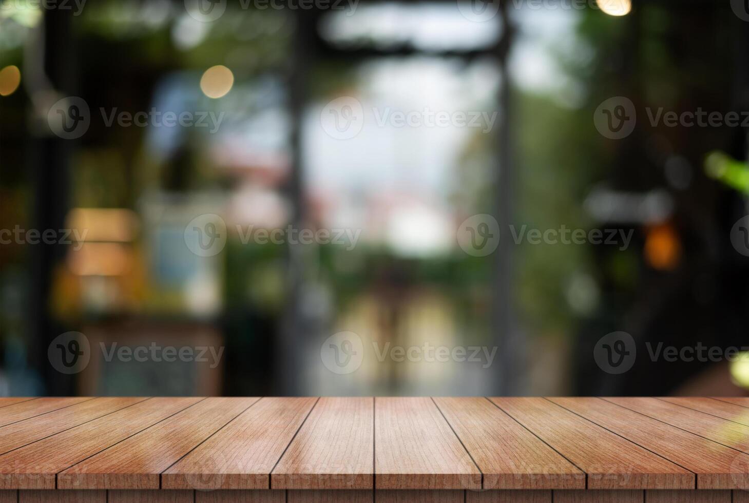 Empty wooden table top with lights bokeh on blur restaurant background. photo