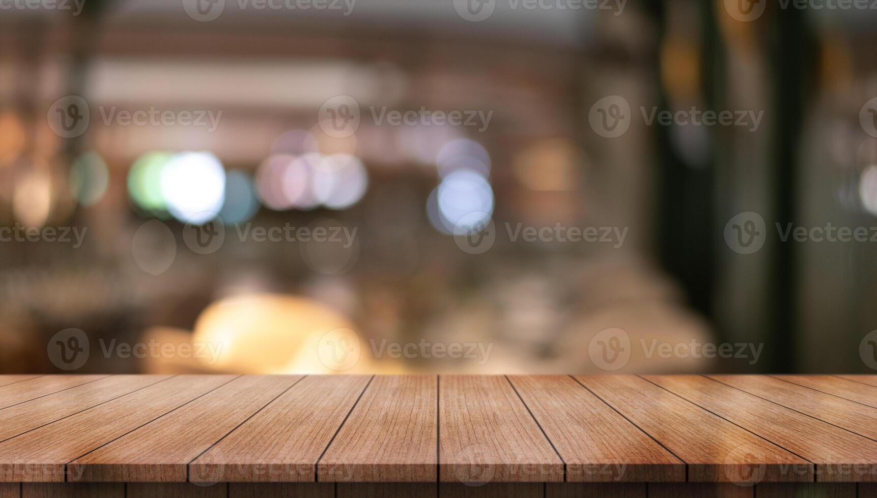 Empty wooden table top with lights bokeh on blur restaurant background photo