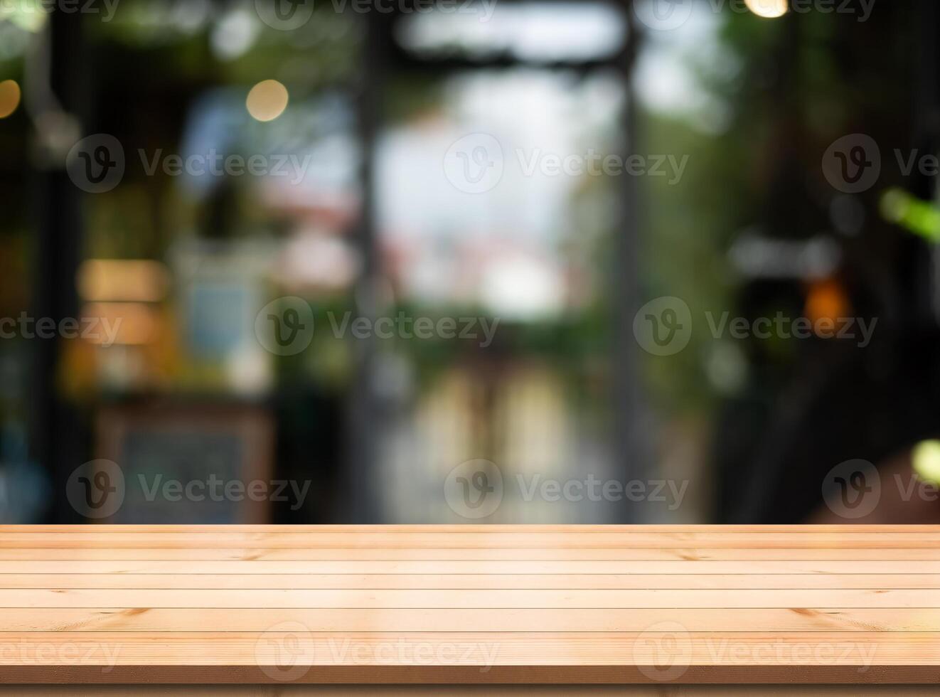 Empty wooden table top with lights bokeh on blur restaurant background. photo