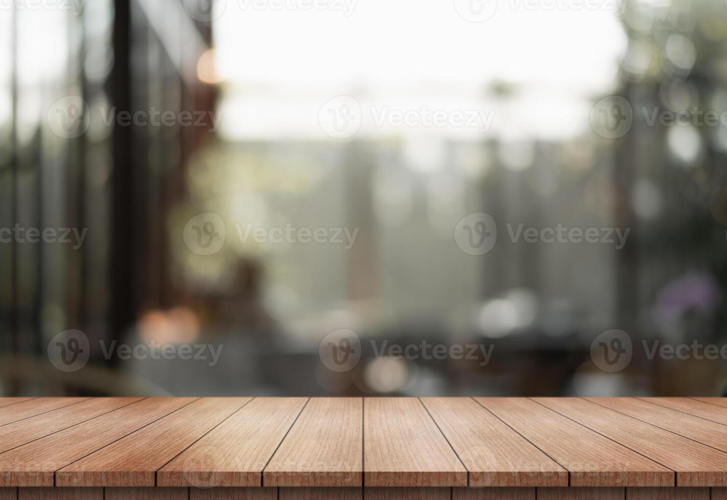 Empty wooden table top with lights bokeh on blur restaurant background. photo