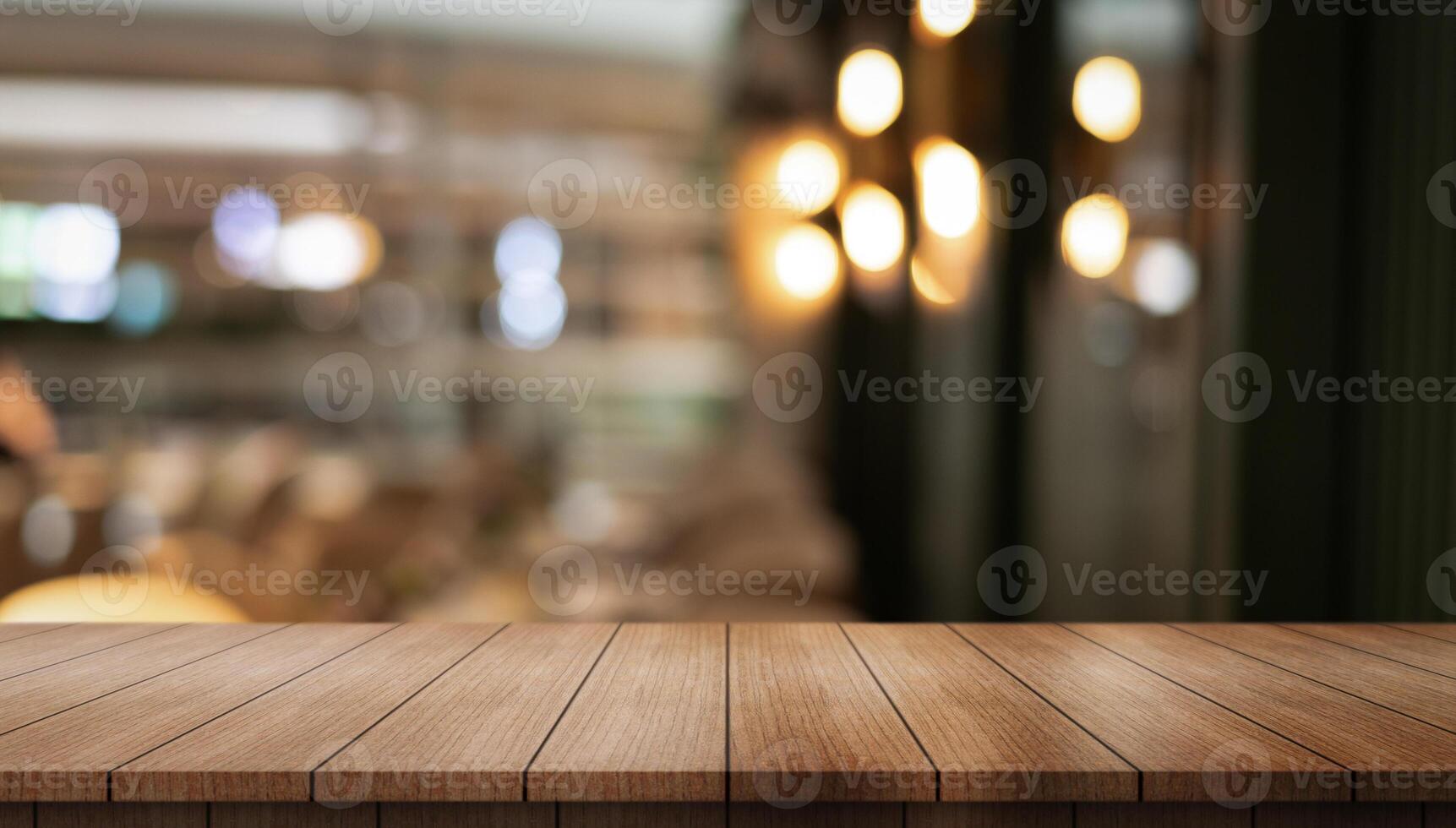 Empty wooden table top with lights bokeh on blur restaurant background photo