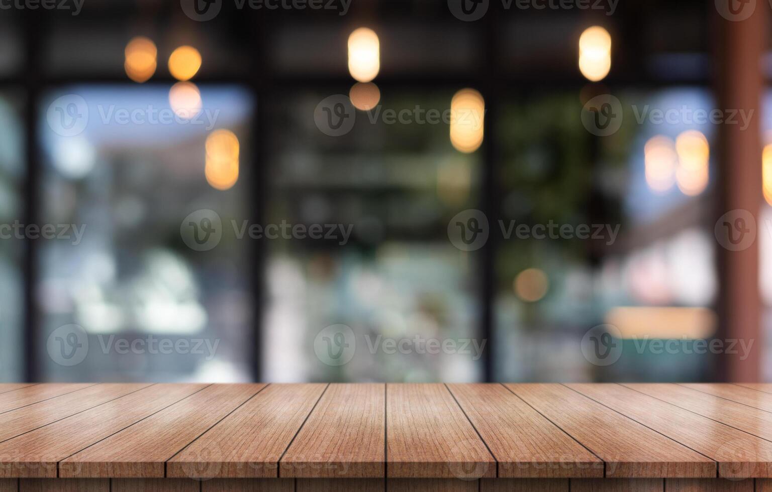 Empty wooden table top with lights bokeh on blur restaurant background. photo