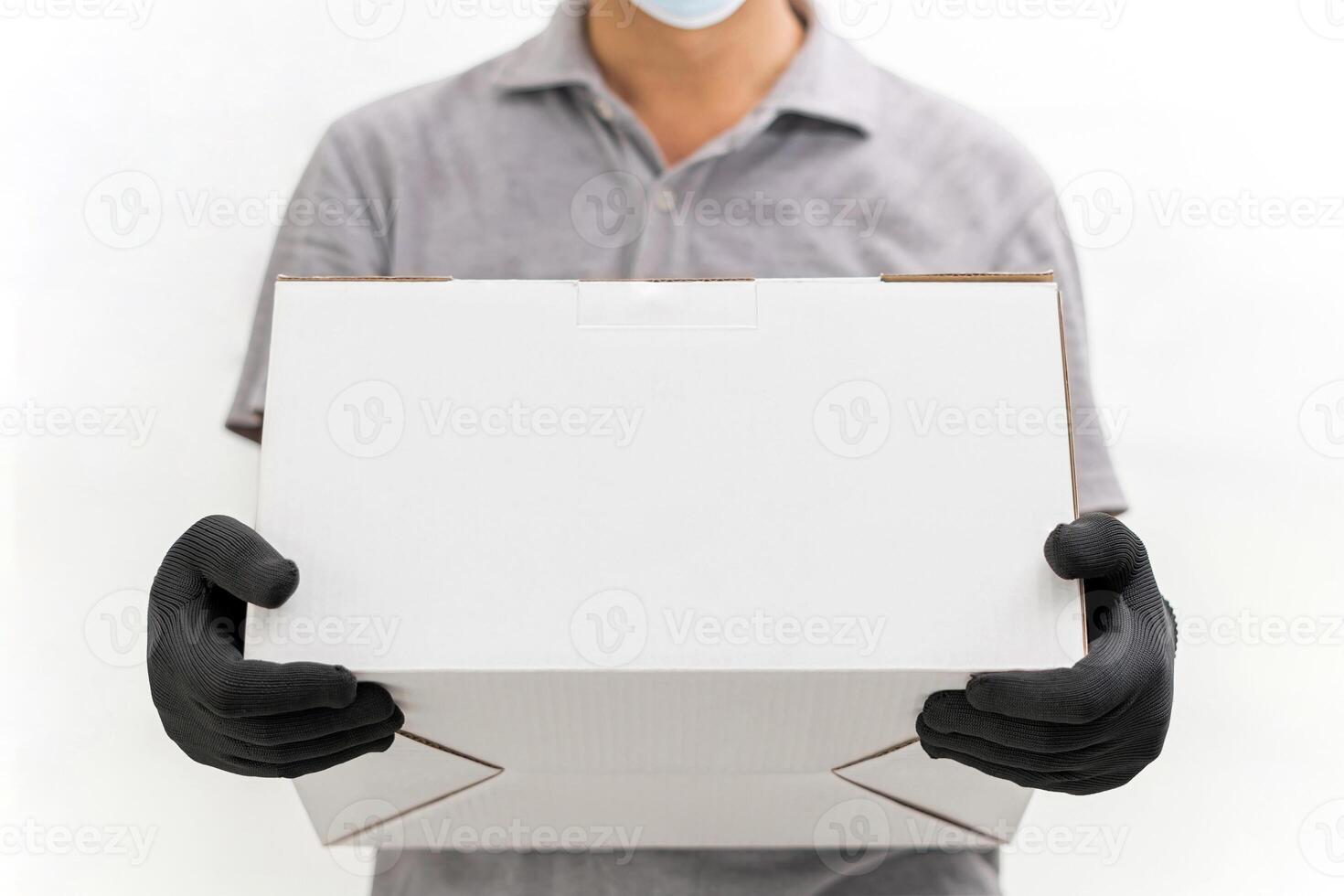 Man use hand to lift the shopping box wearing gloves and protective mask for protection in delivery work with white cement wall background photo